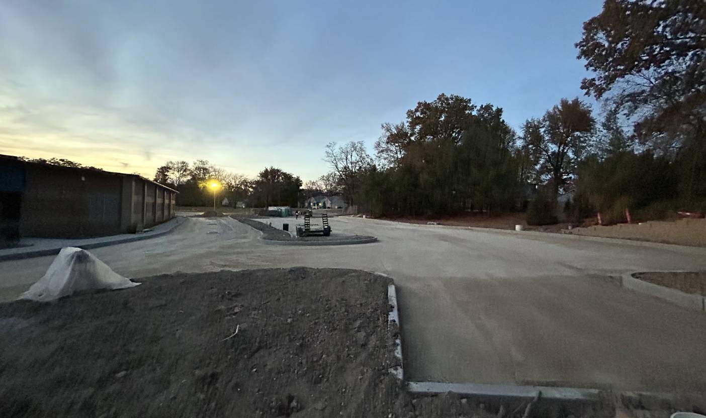 Large commercial property showing complete subgrade preparation and new concrete curbing, ready for asphalt paving by K&K Asphalt Services