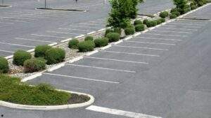 Well-maintained commercial parking lot featuring fresh sealcoating, crisp white line striping, and landscaped islands in Missouri.